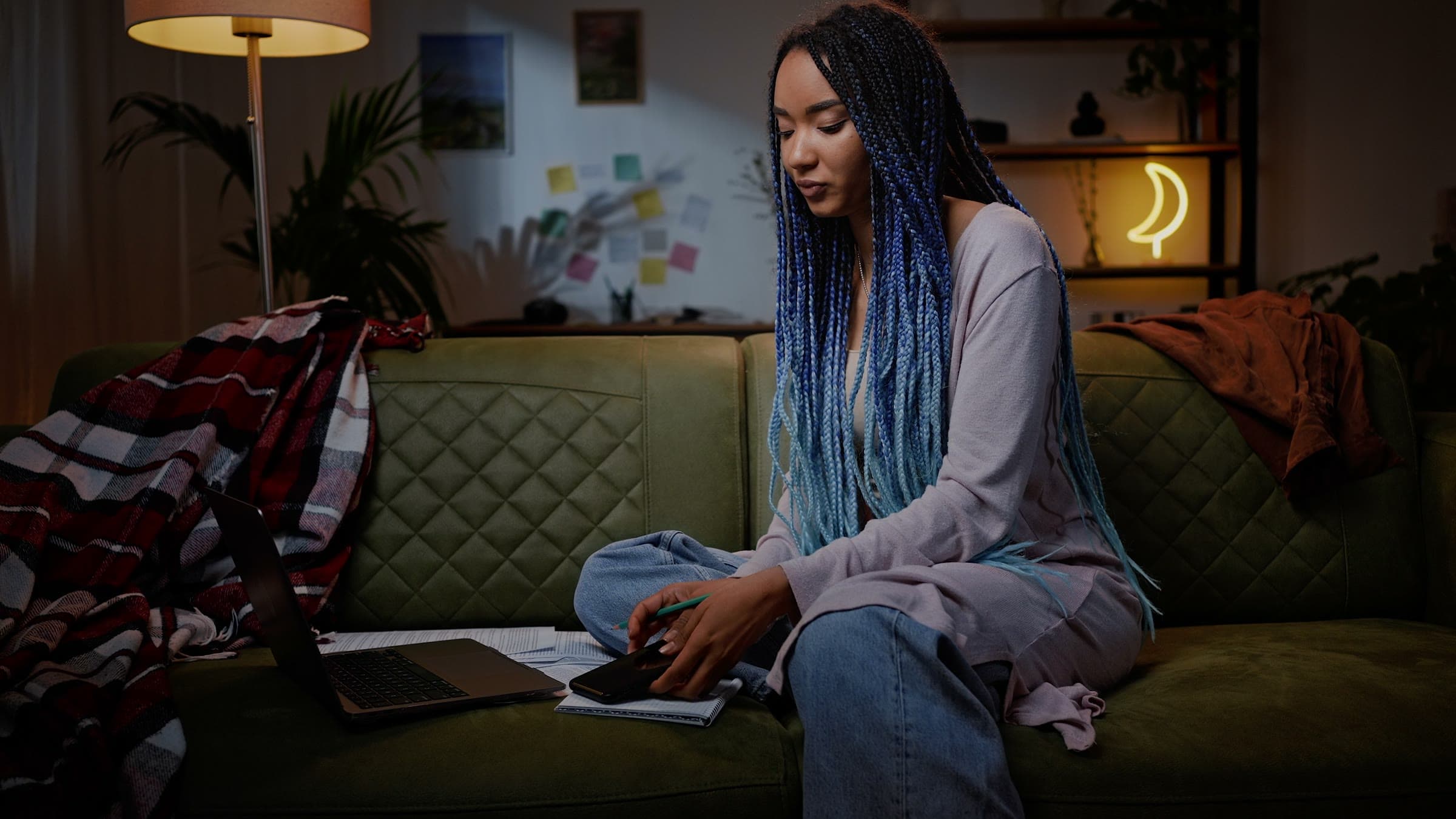 A student studying on her sofa